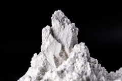Kaolin on black isolated, powdered background. Kaolin is a mineral of inorganic constitution